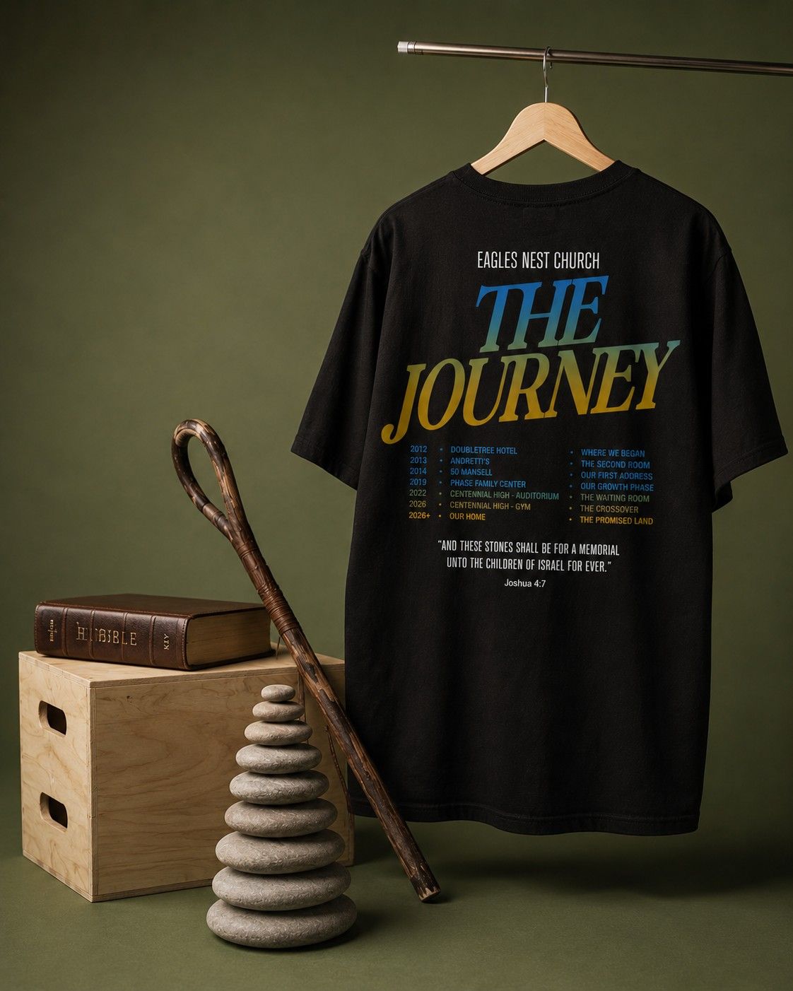 Black Eagles Nest Church tee with The Journey graphic displayed on a hanger