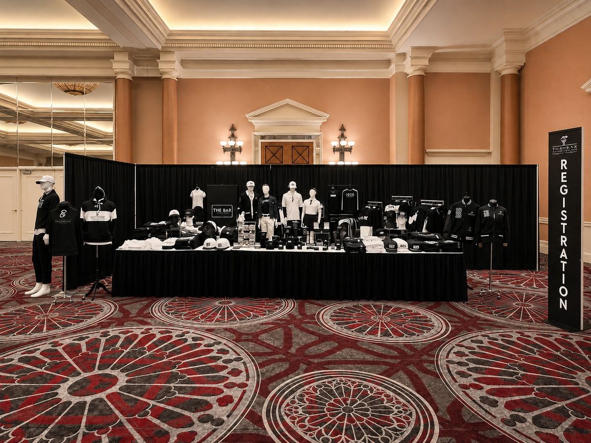 National Bar Association conference store beside a registration banner in a hotel ballroom