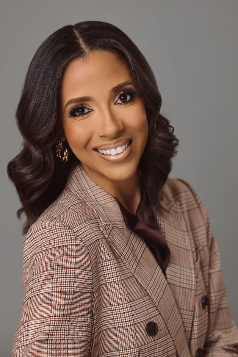 Portrait of Ashley Swain in a plaid blazer