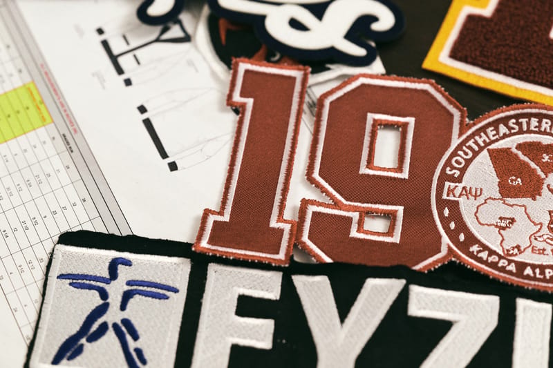 Embroidered chenille numbers and patches arranged over apparel spec sheets