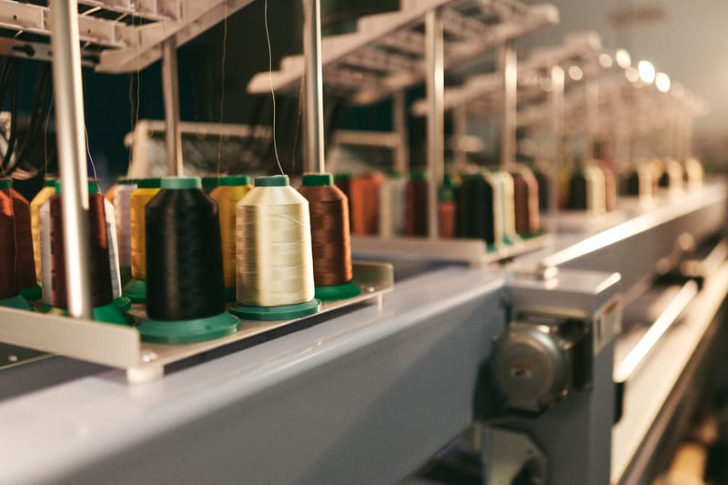 Rows of thread cones on an industrial embroidery machine
